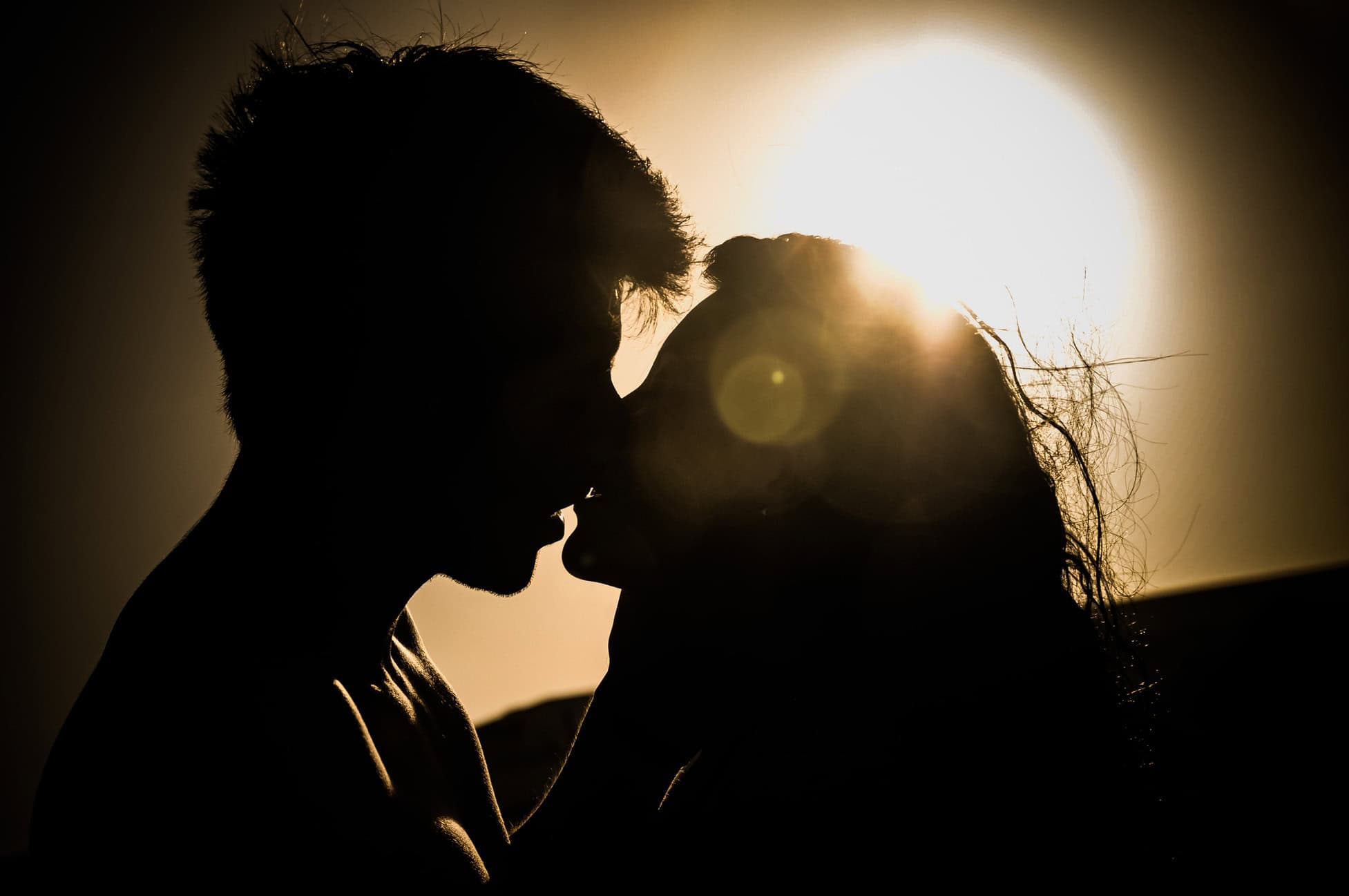 A couple embracing closely, their shadows cast on the wall, symbolizing intimacy, connection, and rekindled desire