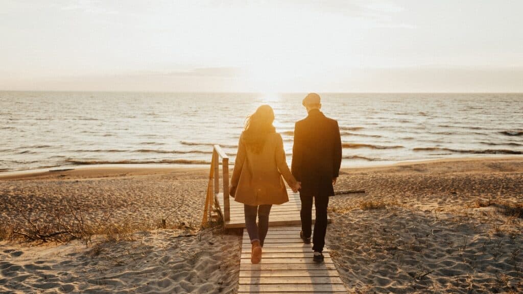 Midlife couple walking on beach