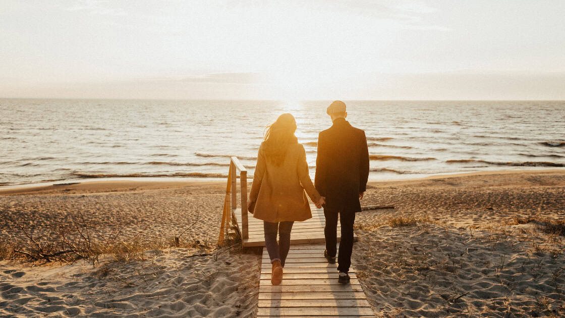 Midlife couple walking on beach