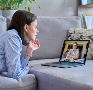 Online therapy meeting of young woman with psychologist
